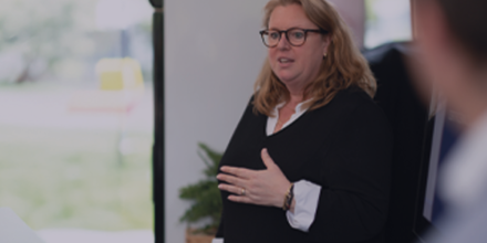 Medewerker geeft training op kantoor aan cursisten