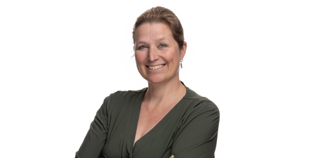 Color portrait photo of a person with crossed arms wearing a dark green blouse.